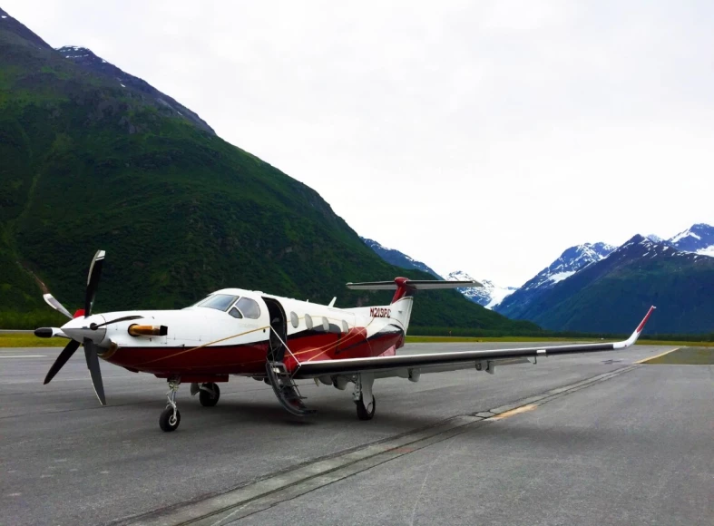 Photo of a Pilatus-PC-12 plane on a runway in Alaska.