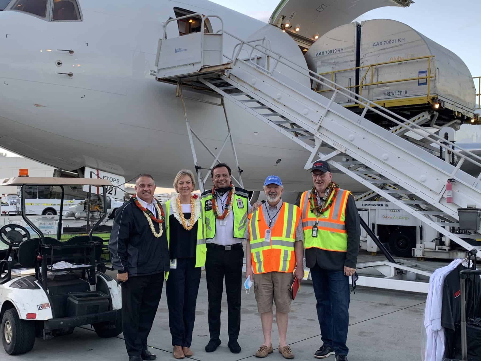 Employees standing in front of a Northern Air Cargo plane.