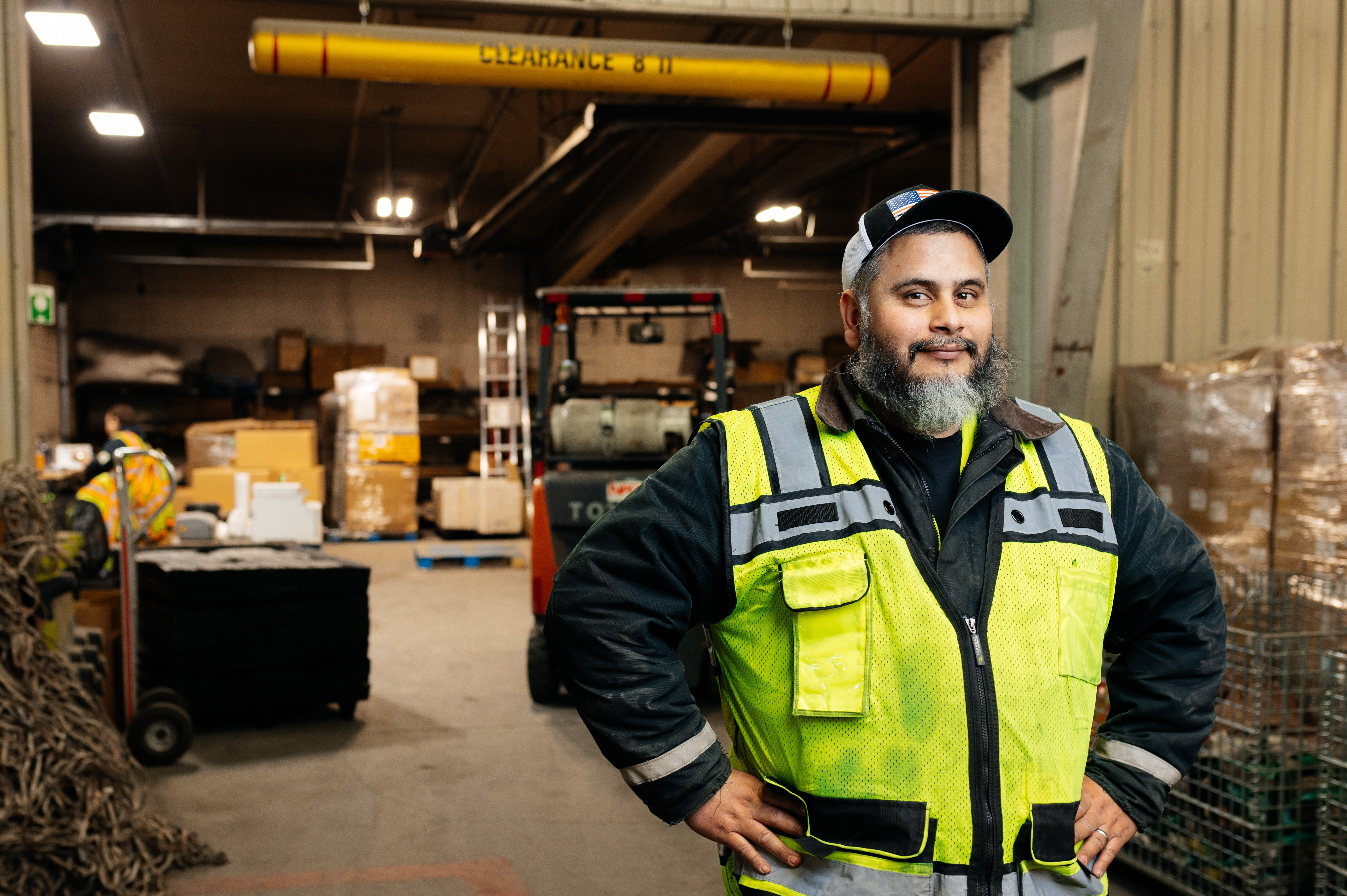 NAC employee standing in front of the Dangerous Goods Department of the warehouse.