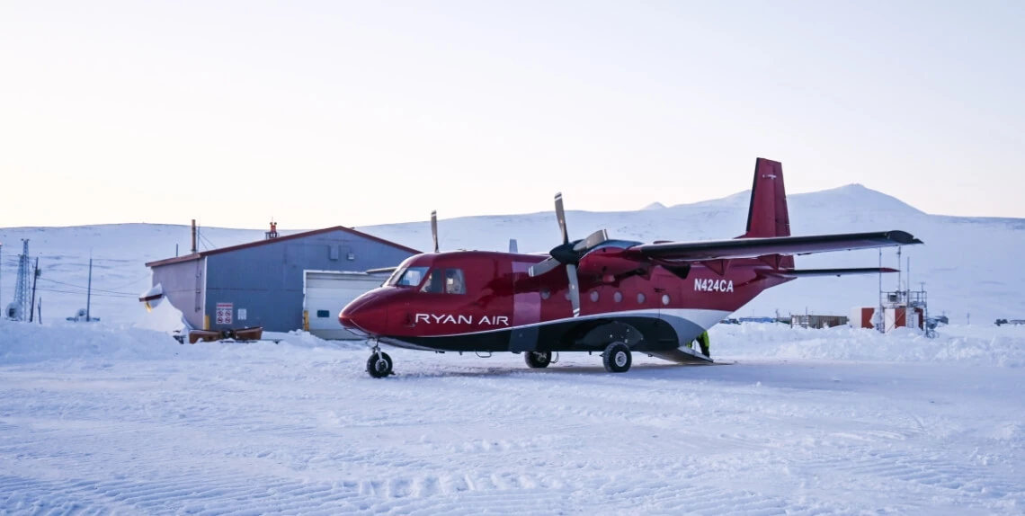 Photo of a Ryan Air airplane on a snowy runway.