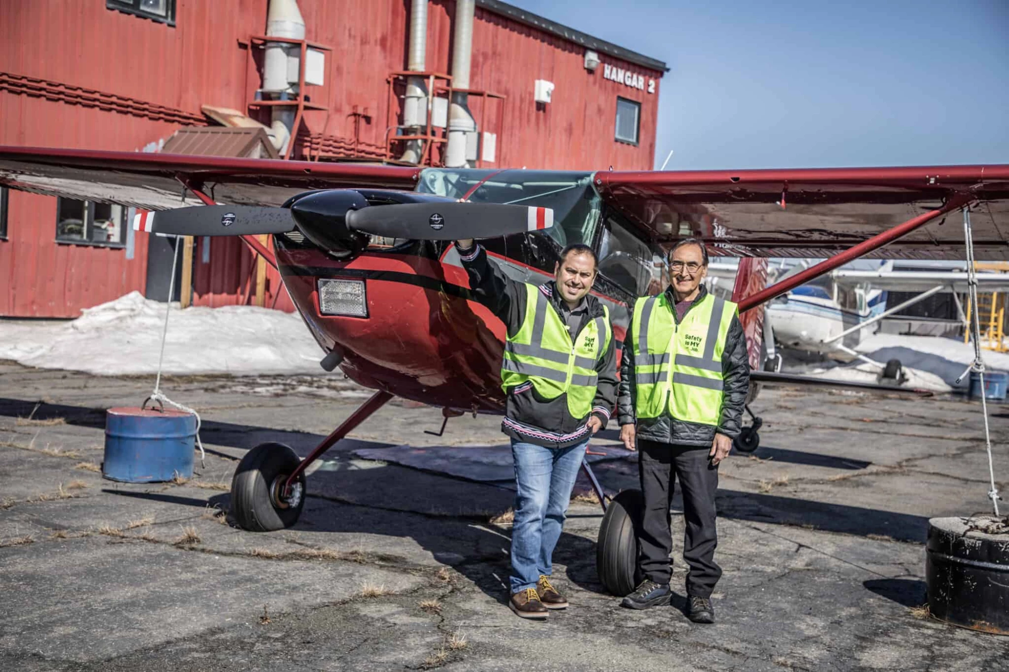 Photo of Lee and Wilfred Ryan standing in front of a Ryan Air plane.