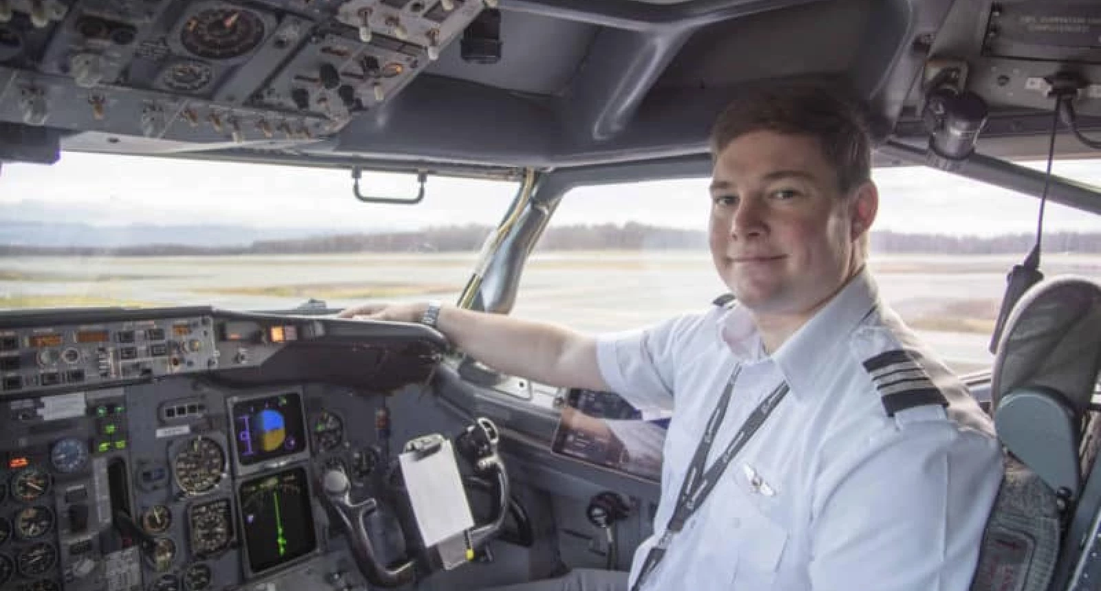 Photo of a NAC pilot sitting in the cockpit of a plane.