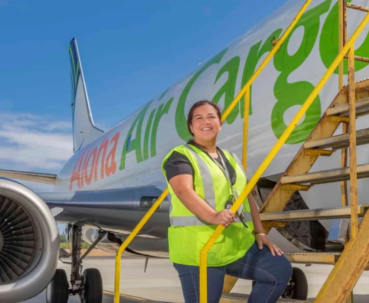 Photo of an Aloha Tech Ops employee boarding a plane.