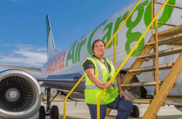 Photo of an Aloha Tech Ops employee boarding a plane.