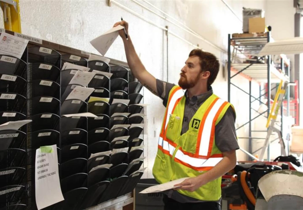 A NAMS employee putting paperwork in mail slots.