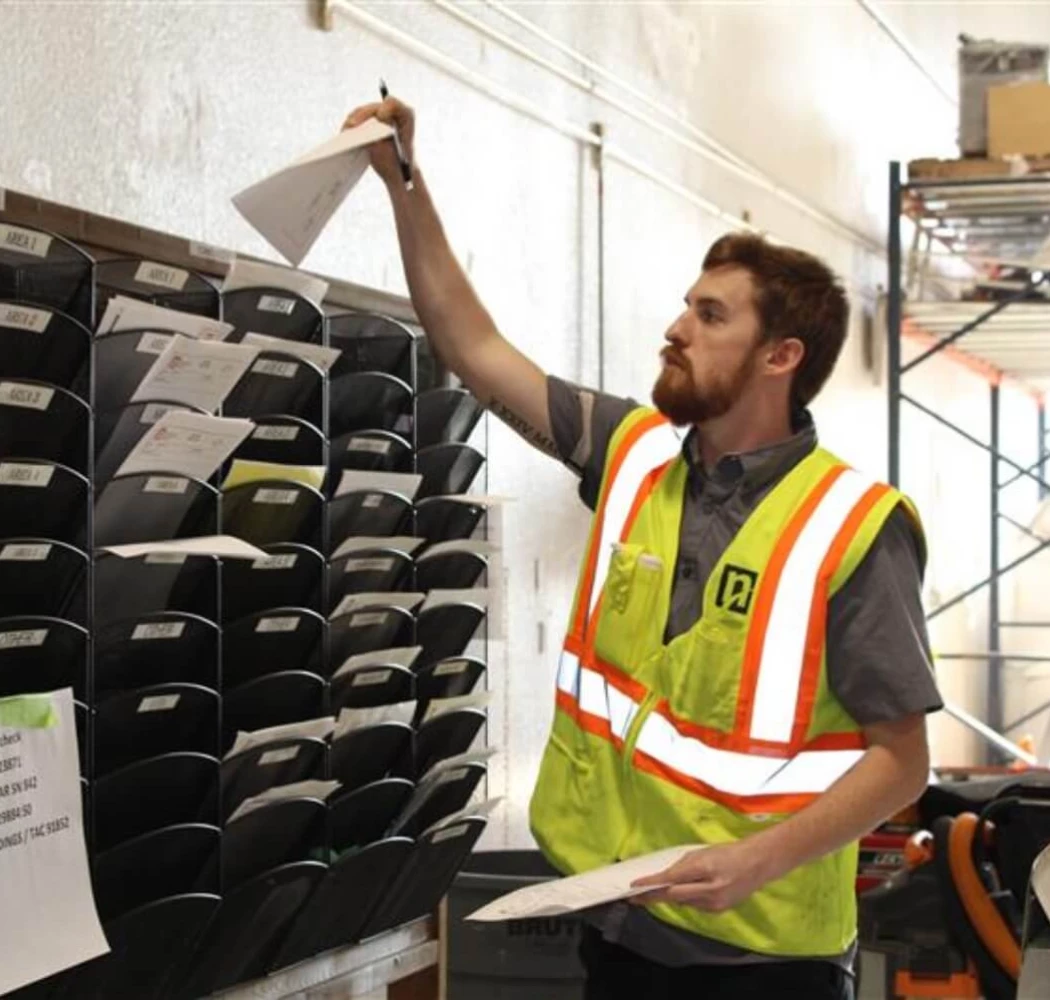 A NAMS employee putting paperwork in mail slots.