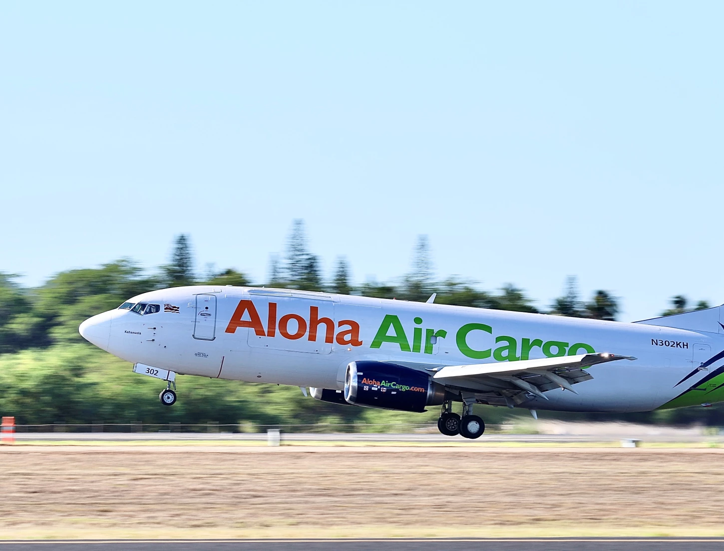 Aloha Air Cargo plane taking off on the runway.