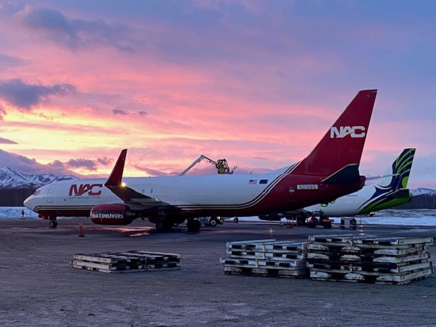 A NAC plane on the ramp in Anchorage in winter being de-iced.
