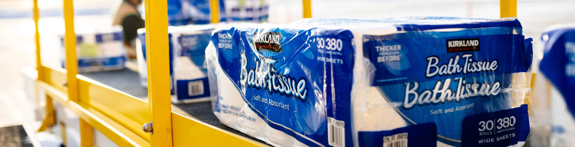 Pallets of bath tissue being loaded onto the conveyor belt arriving into the belly of the aircraft for transport in Alaska.